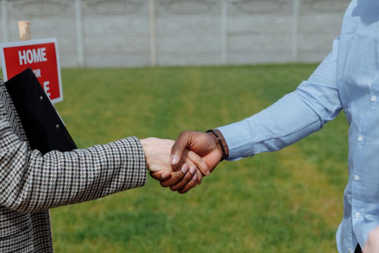 Two individual handshaking for a house offers.